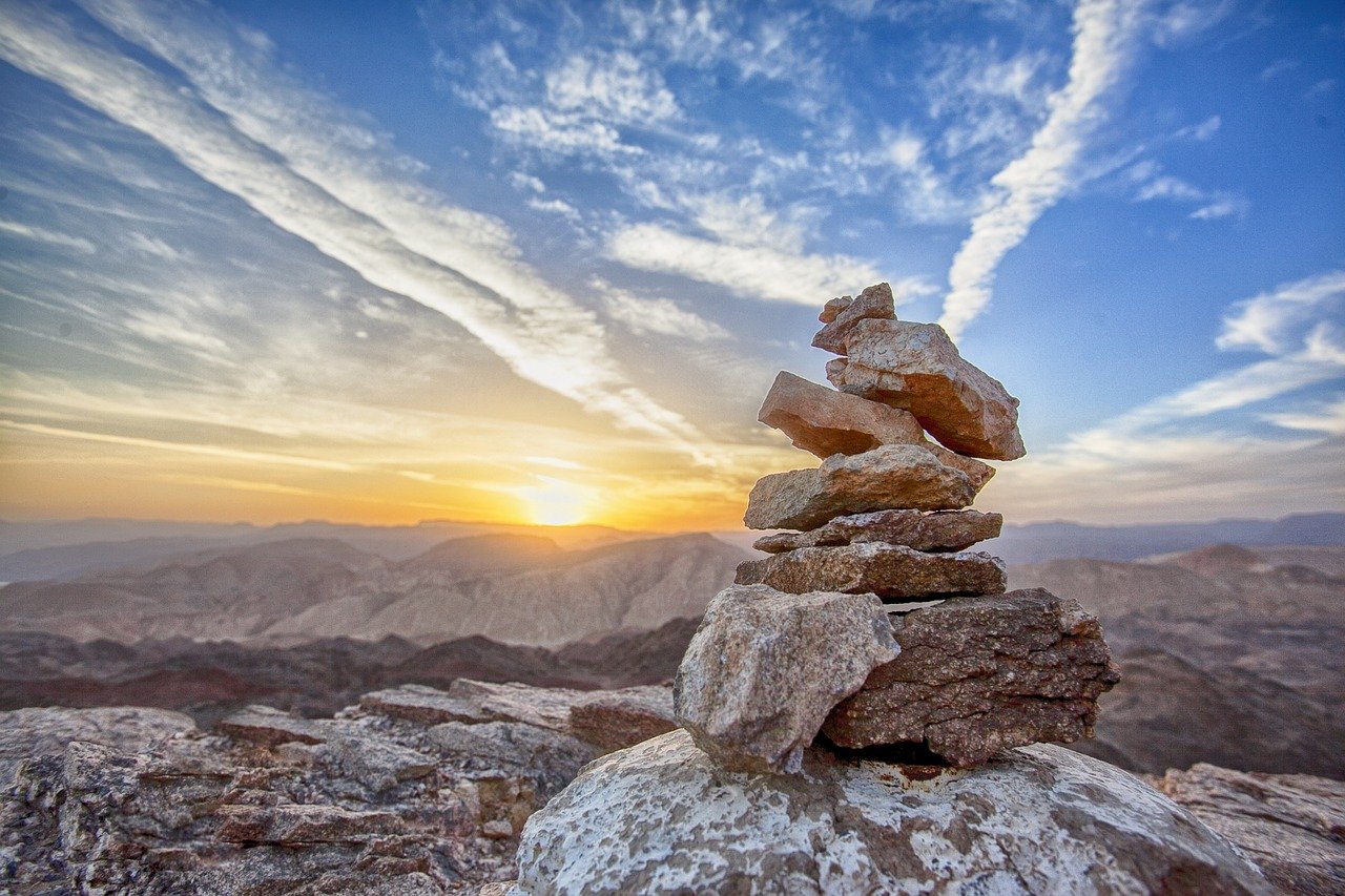 Stacked rocks against a sunset.